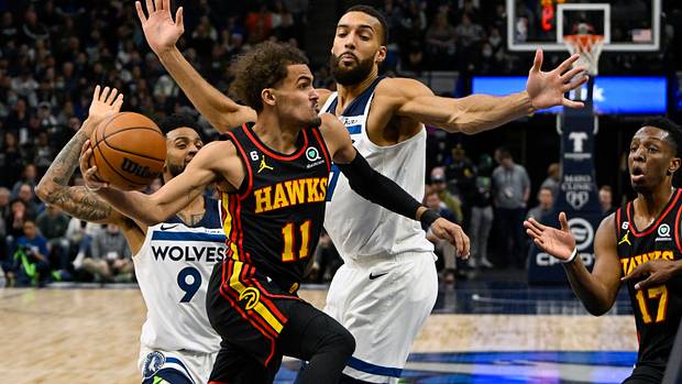 Atlanta Hawks guard Trae Young makes a pass around Minnesota Timberwolves center Rudy Gobert.