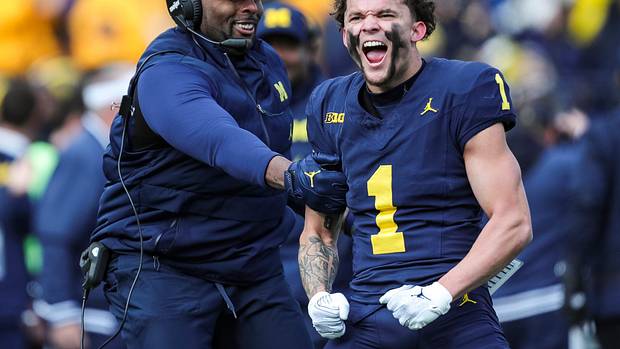 Michigan receiver Roman Wilson and acting head coach/offensive coordinator Sherrone Moore celebrate Wilson's touchdown catch against Ohio State during the first half at Michigan Stadium in Ann Arbor