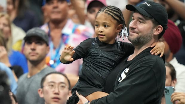 Alexis Ohanian and Alexis Olympia Ohanian Jr. watch Serena Williams during the first round of the 2022 U.S. Open