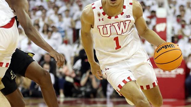 Wisconsin Badgers guard Johnny Davis (1) takes the ball past Purdue Boilermakers guard Eric Hunter Jr. (left) at the Kohl Center.
