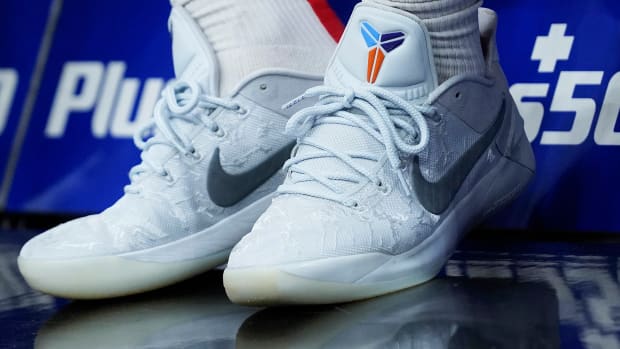 View of white Nike Kobe shoes.