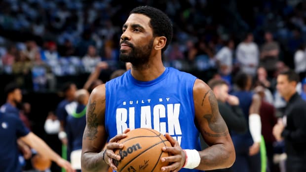 Dallas Mavericks guard Kyrie Irving warms up before a game.