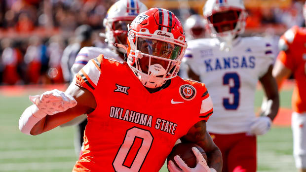 Oct 14, 2023; Stillwater, Oklahoma, USA; Oklahoma State's Ollie Gordon II (0) runs the ball in the second quarter for a touchdown against the Kansas Jayhawks at Boone Pickens Stadium. Mandatory Credit: Nathan J. Fish-USA TODAY Sports