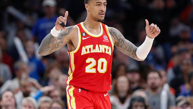 Hawks forward John Collins celebrates a play.