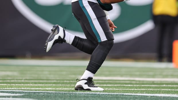 Side view of Philadelphia Eagles quarterback Jalen Hurts' white and black Air Jordan cleats.
