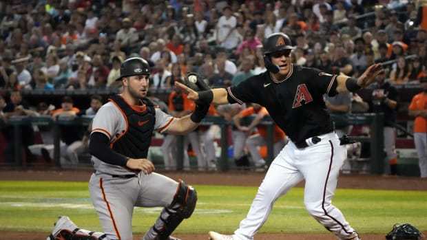 Dbacks outfielder Daulton Varsho and SF Giants catcher Joey Bart turn to the umpire after a play at the plate. (2022)