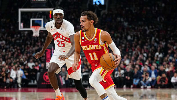 Hawks guard Trae Young drives to the rim against Raptors forward Chris Boucher.