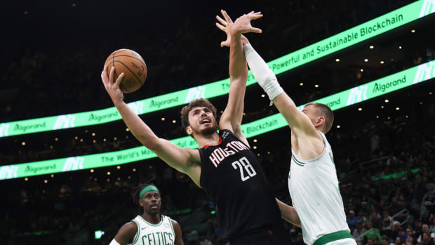 Houston Rockets center Alperen Sengun finishes over Boston Celtics center Kristaps Porzingis