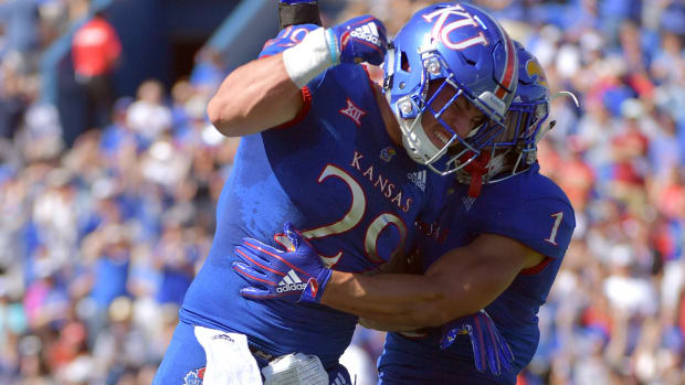 Sep 15, 2018; Lawrence, KS, USA; Kansas Jayhawks safety Bryce Torneden (1) celebrates with linebacker Joe Dineen Jr. (29) after recovering a fumble during the first half against the Rutgers Scarlet Knights at Memorial Stadium. Mandatory Credit: Denny Medley-USA TODAY Sports