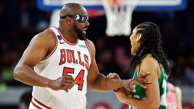 Feb 14, 2020; Chicago, Illinois, USA; Former Chicago Bulls player Horace Grant, playing for Team Wilbon, laughs with A ja Wilson during the NBA All Star-Celebrity Game at Wintrust Arena.