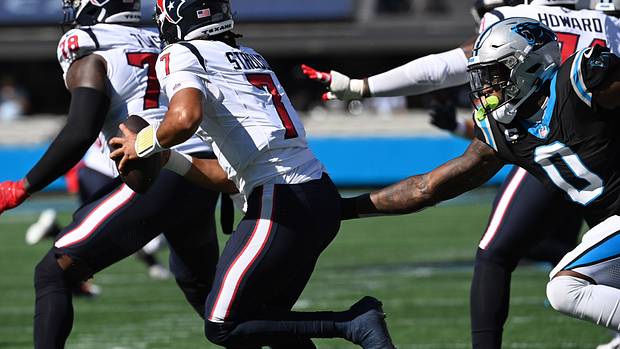 Houston Texas QB C.J. Stroud pressured by the Panthers defense