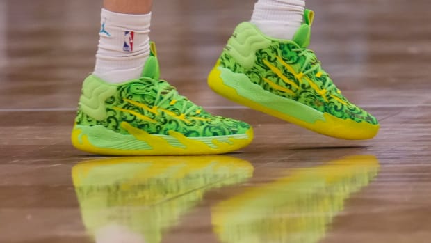 Charlotte Hornets guard LaMelo Ball's green and yellow PUMA shoes.