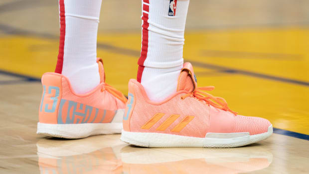 View of James Harden's coral adidas shoes.
