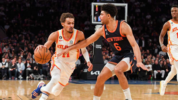 Hawks guard Trae Young dribbles past Knicks guard Quentin Grimes.