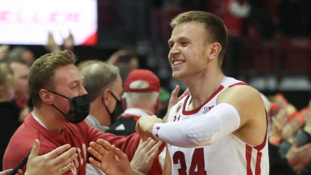 Wisconsin guard Brad Davison interacting with fans after a win at the Kohl Center (Credit: Mary Langenfeld-USA TODAY Sports)