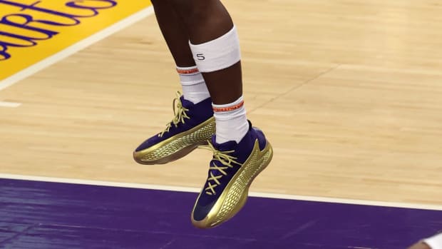 Minnesota Timberwolves guard Anthony Edwards' purple and gold adidas sneakers.