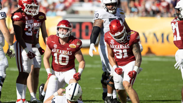 Jan 1, 2022; Tampa, FL, USA; Arkansas Razorbacks linebacker Bumper Pool (10) and linebacker Grant Morgan (31) celebrate after a sack during the second half against the Penn State Nittany Lions during the 2022 Outback Bowl at Raymond James Stadium. Mandatory Credit: Matt Pendleton-USA TODAY Sports