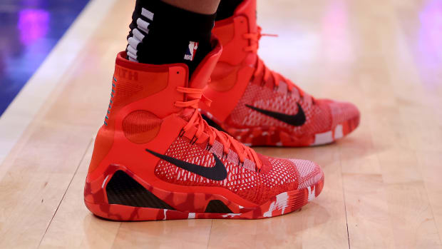 Side view of Kobe Bryant's red and black Nike sneakers.