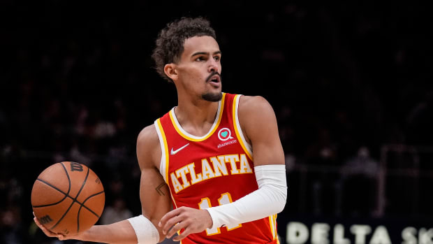 Atlanta Hawks guard Trae Young (11) handles the ball against the Charlotte Hornets during the second half at State Farm Arena.