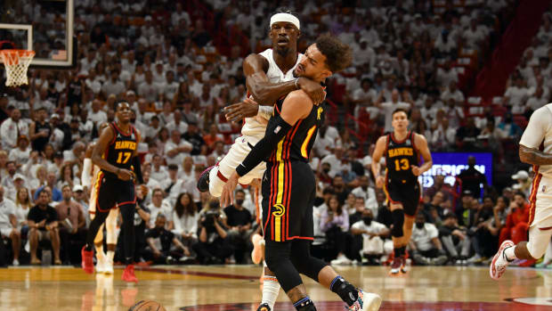 Apr 17, 2022; Miami, Florida, USA; Miami Heat forward Jimmy Butler (22) and Atlanta Hawks guard Trae Young (11) collide during the first half of game one of the first round for the 2022 NBA playoffs at FTX Arena.