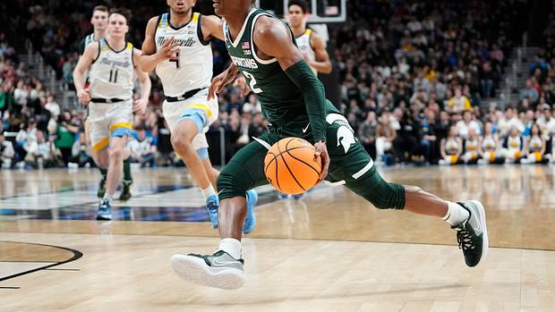 Michigan State Spartans guard Tyson Walker dribbles to the rim.