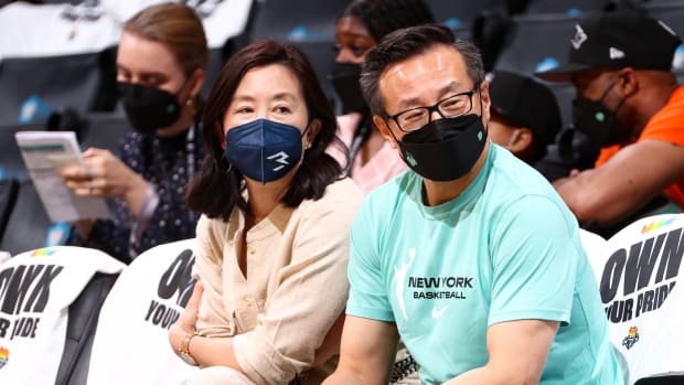 Clara Wu Tsai and Joe Tsai sitting courtside at a New York Liberty game