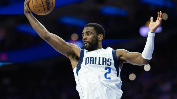 Dallas Mavericks guard Kyrie Irving (2) reaches for a rebound against the Philadelphia 76ers during the fourth quarter at Wells Fargo Center. Mandatory Credit: