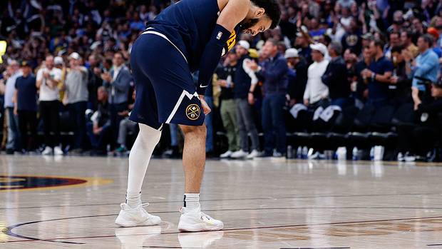 Denver Nuggets guard Jamal Murray looks down during a game.