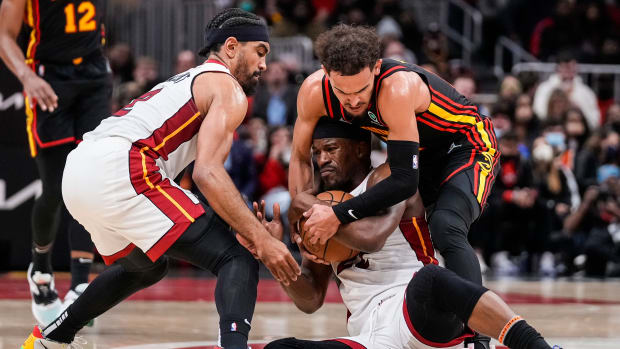 Jan 21, 2022; Atlanta, Georgia, USA; Miami Heat forward Jimmy Butler (22) and Atlanta Hawks guard Trae Young (11) fight for the ball on the court during the second half at State Farm Arena.