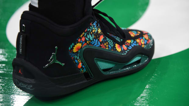 Boston Celtics forward Jayson Tatum's black and green Jordan Brand sneakers.