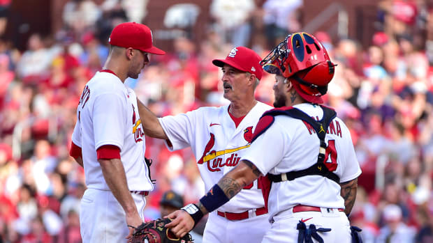 Jun 15, 2022; St. Louis, Missouri, USA; St. Louis Cardinals starting pitcher Jack Flaherty (22) talks with pitching coach Mike Maddux (31) and catcher Yadier Molina (4) during the first inning against the Pittsburgh Pirates at Busch Stadium. Mandatory Credit: Jeff Curry-USA TODAY Sports