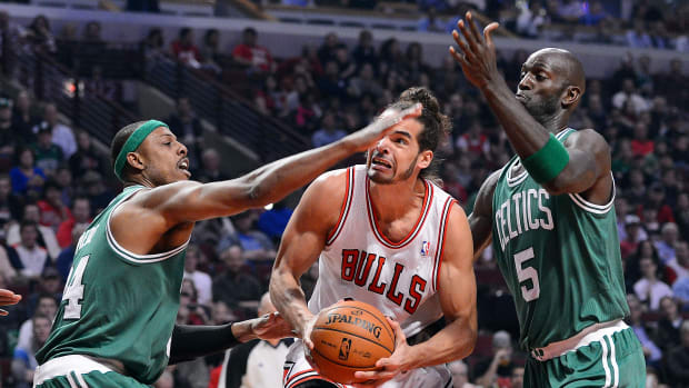 Nov 12, 2012; Chicago, IL, USA; Chicago Bulls center Joakim Noah (13) attempts to shoot the ball against Boston Celtics small forward Paul Pierce (34) and power forward Kevin Garnett (5) during the first half at the United Center.