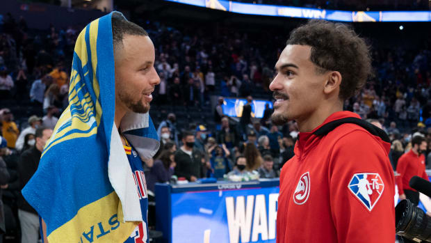 Golden State Warriors guard Stephen Curry (30) and Atlanta Hawks guard Trae Young (11) talk after the game at Chase Center.