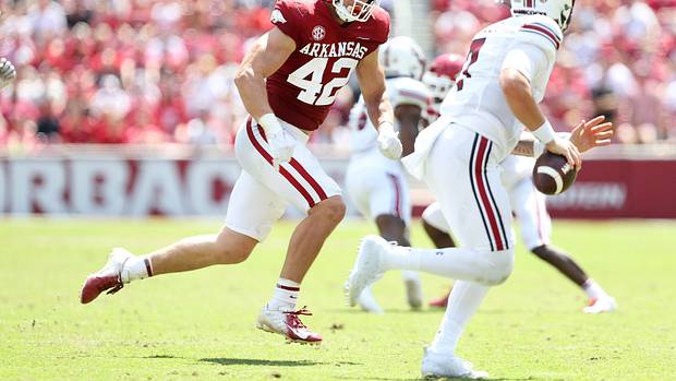 Arkansas Razorbacks linebacker Drew Sanders (42) pursues South Carolina Gamecocks quarterback Spencer Rattler (7) during the second half at Donald W. Reynolds Razorback Stadium. Arkansas won 44-30.