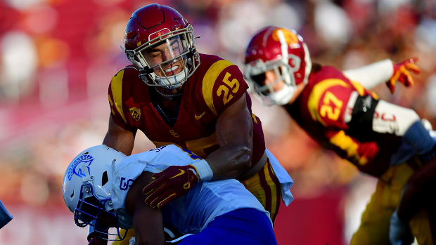 Aug 26, 2023; Los Angeles, California, USA; Southern California Trojans linebacker Tackett Curtis (25) brings down San Jose State Spartans wide receiver Isaac Jernagin (0) during the first half at Los Angeles Memorial Coliseum.