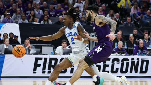 UCLA Bruins guard Dylan Andrews dribbles past Northwestern Wildcats guard Boo Buie.