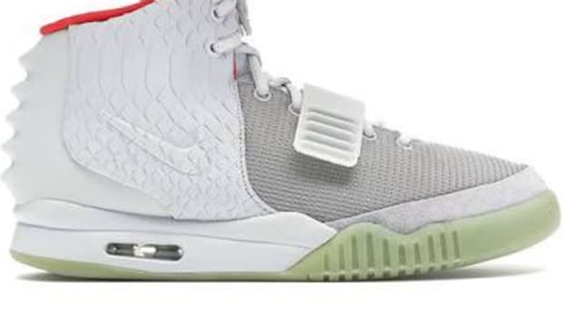 View of white, grey, and red Nike Air Yeezy 2 shoes.