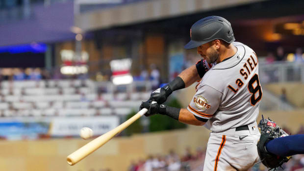 SF Giants infielder Tommy La Stella hits a sacrifice fly against the Twins.