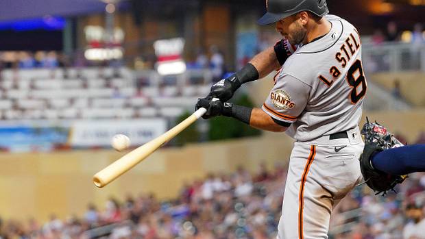 SF Giants infielder Tommy La Stella hits a sacrifice fly against the Twins.