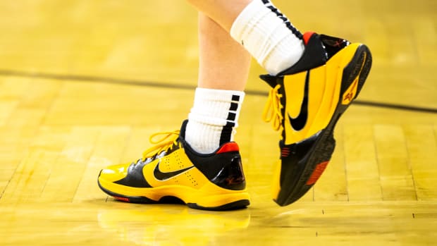 Iowa Hawkeyes guard Caitlin Clark's black and gold Nike Kobe sneakers.