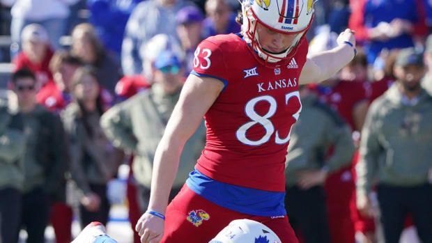 Nov 6, 2021; Lawrence, Kansas, USA; Kansas Jayhawks place kicker Jacob Borcila (83) kicks the point after from the hold of punter Reis Vernon (24) against the Kansas State Wildcats during the game at David Booth Kansas Memorial Stadium. Mandatory Credit: Denny Medley-USA TODAY Sports