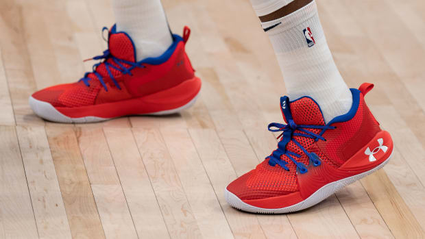 View of red, white, and blue Under Armour shoes.