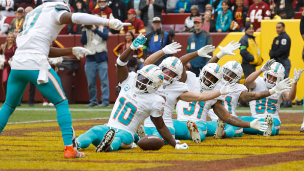 Miami Dolphins wide receiver Tyreek Hill (10) celebrates in the end zone after catching a touchdown pass against the Washington Commanders during the first quarter at FedExField.