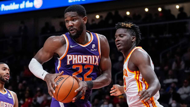 Feb 3, 2022; Atlanta, Georgia, USA; Phoenix Suns center Deandre Ayton (22) controls a rebound in front of Atlanta Hawks center Clint Capela (15) during the first half at State Farm Arena.