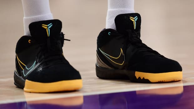 View of black and gold Nike Kobe shoes.