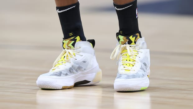 View of white and yellow Air Jordan shoes.