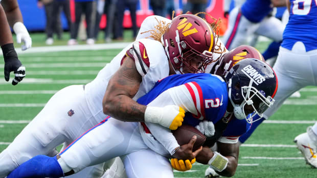 Washington Commanders defensive end Chase Young (99) sacks New York Giants quarterback Tyrod Taylor (2) in the second half at MetLife Stadium.