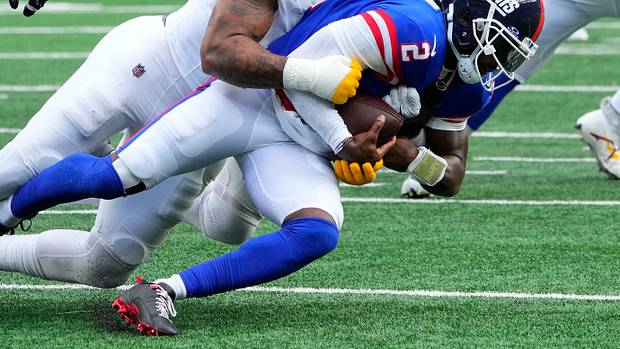 Washington Commanders defensive end Chase Young (99) sacks New York Giants quarterback Tyrod Taylor (2) in the second half at MetLife Stadium.