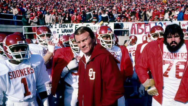 Oklahoma Sooners head coach Barry Switzer leads his team on the field against the Nebraska Cornhuskers at Memorial Stadium.