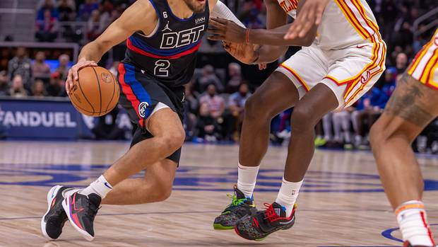 Pistons guard Cade Cunningham drives to the basket on Hawks center Clint Capela.
